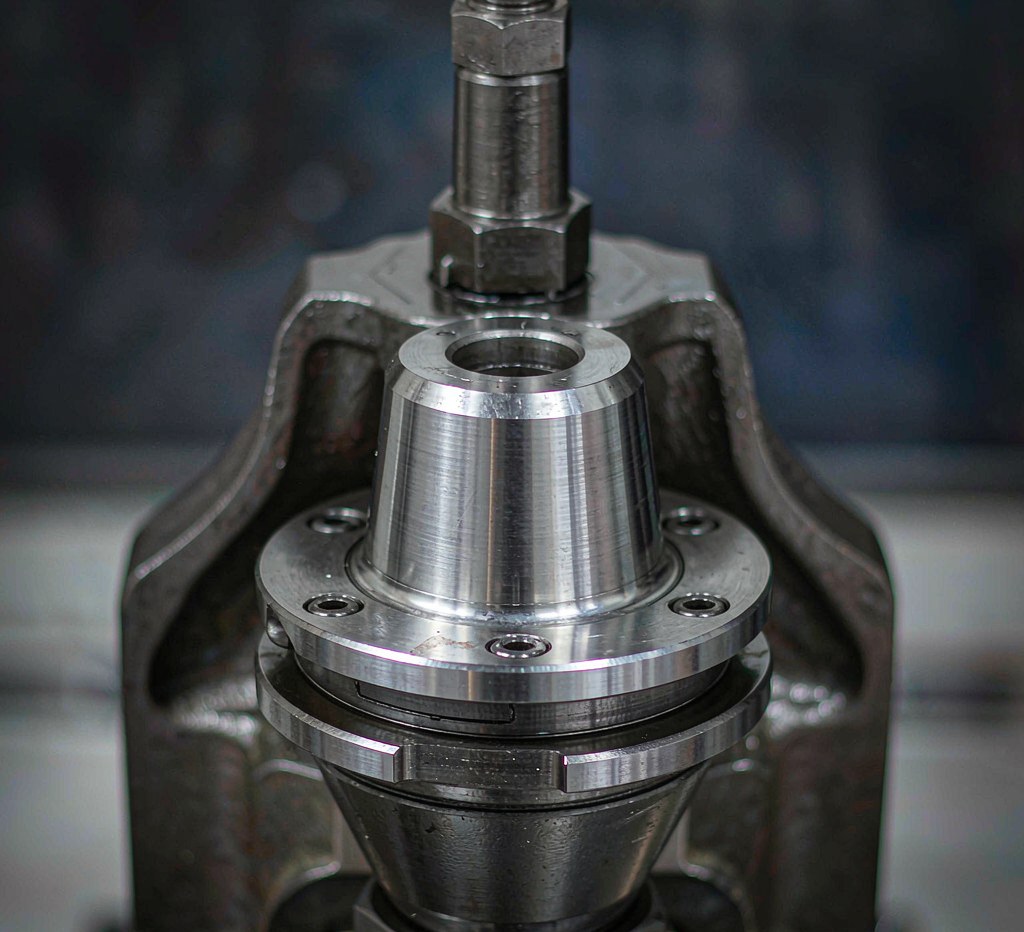 close-up of a CNC machine spindle nose and taper showing precision machined steel surfaces